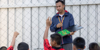 coach teaching children